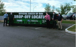 Subaru employees in front of trash dumpster